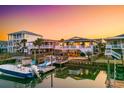 Relaxing waterfront backyard featuring a private dock, comfortable seating, and views of neighboring coastal homes at 40 Fairmont St., Ocean Isle Beach, NC 28469