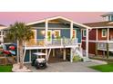 Beautiful raised beach house with golf cart parking and a peek at the outdoor entertainment area underneath the home at 40 Fairmont St., Ocean Isle Beach, NC 28469