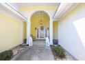 Inviting entryway featuring decorative columns, lion statues, a hanging lantern, and decorative wreath on the door at 4244 Luck Ave., Little River, SC 29566