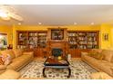 Cozy living room boasts built-in bookshelves, a fireplace, comfortable seating, and decorative area rug at 4244 Luck Ave., Little River, SC 29566