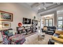 Open-concept living room with tray ceiling, modern furniture, and ample natural light at 45 Dornoch Dr., Pawleys Island, SC 29585