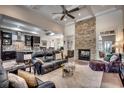 Cozy living room featuring a stone fireplace and open access to dining and kitchen areas at 45 Dornoch Dr., Pawleys Island, SC 29585