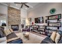 Inviting living room with stone fireplace, ceiling fan, and built-in shelving at 45 Dornoch Dr., Pawleys Island, SC 29585