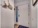 Bright entryway featuring a white door with a window and nautical decor, creating a welcoming atmosphere at 126 N Waccamaw Dr. # 203, Garden City Beach, SC 29576