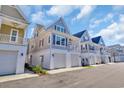 Charming coastal homes highlight covered garages and welcoming balconies on a clear, sunny day at 138 Marblehead Dr., Little River, SC 29566