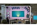 Aerial of outdoor area featuring pool, hot tub, lounge chairs and tables, all contained in a fenced backyard at 1420 S Ocean Blvd., North Myrtle Beach, SC 29582