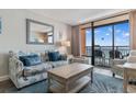 Cozy living room featuring a large window with balcony access and ocean views at 1501 S Ocean Blvd. # 633, Myrtle Beach, SC 29577