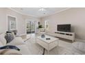 Bright living room features neutral decor, a glass sliding door, tile flooring, and a comfortable seating arrangement at 160 Lazy Willow Ln. # 204, Myrtle Beach, SC 29577