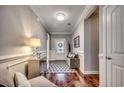 Elegant entryway with hardwood floors, decorative wainscoting, and a stylish chandelier. It has neutral color palette at 1903 Francis Ct., Myrtle Beach, SC 29577