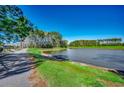 Scenic pond view on a sunny day with lush green grass and mature trees surrounding the area at 1903 Francis Ct., Myrtle Beach, SC 29577
