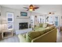 Bright living room features a white brick fireplace, stylish furnishings, and lots of natural light at 206B 56Th Ave. N, North Myrtle Beach, SC 29582
