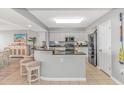 Open-concept kitchen with modern appliances, stone countertops and barstool seating at 2151 Bridge View Ct. # 1-803, North Myrtle Beach, SC 29582