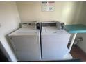 Laundry area with two top-load washing machines and posted laundry use and property management rules at 2708 S South Ocean Blvd. # 102, Myrtle Beach, SC 29577