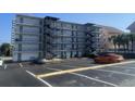 View of the back of the building with access to the parking lot with painted parking spaces at 2708 S South Ocean Blvd. # 102, Myrtle Beach, SC 29577