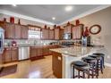 Well-equipped kitchen with stainless steel appliances, granite countertops, breakfast bar, and hardwood floors at 300 Lorenzo Dr., North Myrtle Beach, SC 29582