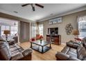 Comfortable living room featuring hardwood floors, leather sofas, a ceiling fan, and sliding door to a patio at 300 Lorenzo Dr., North Myrtle Beach, SC 29582