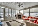 Bright sun room with tile flooring, a fireplace, and comfortable seating area, perfect for relaxing and entertaining at 300 Lorenzo Dr., North Myrtle Beach, SC 29582
