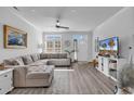 Cozy living room with a large sectional sofa, natural light, and modern entertainment center at 3534 Pampas Dr. # 505, Myrtle Beach, SC 29577