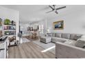 Inviting living area featuring a comfortable gray sectional sofa, light wood floors, and white walls at 3534 Pampas Dr. # 505, Myrtle Beach, SC 29577