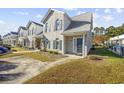 Inviting townhouse features well-maintained landscaping, brick facade, and private driveway at 3936 Tybre Downs Circle # 3936, Little River, SC 29566