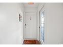 Bright entryway features a welcome mat, charming decor, and a secure door with nearby exit, enhancing a warm ambiance at 4222 Pinehurst Dr. # I-9, Little River, SC 29566