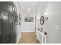 Bright and airy entryway showcasing stylish decor, wood floors, and access to other living spaces at 4856 Bermuda Way N, Myrtle Beach, SC 29577