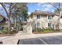 Charming two-story condo building with well-maintained landscaping and exterior stairs to the upper units at 491 Ocean Creek Dr. # 2613, Myrtle Beach, SC 29572