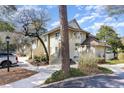 Two-story condo building with well-maintained landscaping, exterior stairs to the upper units, and inviting entryways at 491 Ocean Creek Dr. # 2613, Myrtle Beach, SC 29572
