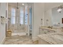 Beautiful bathroom featuring a tiled shower with glass door, rainfall shower head, and granite vanity at 4934 Salt Creek Ct., North Myrtle Beach, SC 29582