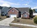 Charming two-story brick home with an attached two-car garage and mature landscaping at 5077 Capulet Circle, Myrtle Beach, SC 29588