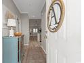 Inviting foyer featuring wood-look flooring, a blue cabinet, and stylish decor at 5834 Longwood Dr. # 303, Murrells Inlet, SC 29576