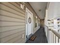 Charming front porch with a decorative door and a welcoming 'Live, Laugh, Love' door mat at 5834 Longwood Dr. # 303, Murrells Inlet, SC 29576