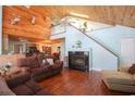 Spacious living room featuring a high ceiling, fireplace, hardwood floors, and a staircase at 5865 Creekside Dr., Myrtle Beach, SC 29588