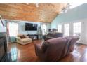 Bright living room with high ceilings, ceiling fans, French doors, and comfortable seating at 5865 Creekside Dr., Myrtle Beach, SC 29588