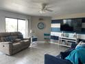 Comfortable living room featuring a neutral color scheme, tile floor, and a sliding glass door to the balcony at 5905 S Kings Highway # B-455, Myrtle Beach, SC 29588