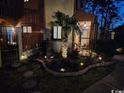 Exterior nighttime view, with landscape lighting and fenced front patio at 614 15Th Ave. S # 42, Surfside Beach, SC 29575
