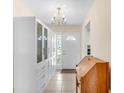 Bright entryway featuring custom built-in storage and tiled floor and a view to the front door at 6634 Cinnamon Fern Ln., Myrtle Beach, SC 29588