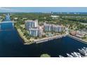 Aerial view of a waterfront condo complex featuring a pool, boat docks, and manicured grounds at 8121 Amalfi Pl. # 4306, Myrtle Beach, SC 29572
