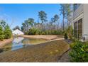 Lush backyard with a serene pond providing a peaceful view at 933 Jackline Place # 101, Murrells Inlet, SC 29576