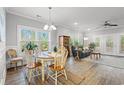 Charming dining area filled with natural light and beautiful hardwood flooring, leading to a comfortable living space at 933 Jackline Place # 101, Murrells Inlet, SC 29576