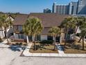 Aerial view of townhomes with palm trees, showcasing proximity to beach and city at 10200 Lake Shore Dr. # 16, Myrtle Beach, SC 29572