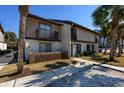 Two-story townhome featuring a balcony, lush landscaping, and sidewalk access at 10200 Lake Shore Dr. # 16, Myrtle Beach, SC 29572