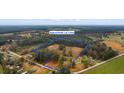 Aerial view of property lot lines, showcasing its expansive acreage with wooded areas and some neighboring houses at 1206 French Rd, Mullins, SC 29574