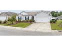 Well-maintained one-story home with lush green lawn and attached two car garage at 1320 Midtown Village Dr., Conway, SC 29526