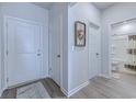 Inviting hallway with white doors and warm-toned floors leading to a full bathroom at 177 Fox Rae Dr., Conway, SC 29526