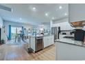 Open concept kitchen with stainless steel appliances, island, and seamless flow to living area at 177 Fox Rae Dr., Conway, SC 29526