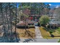 Charming single-story brick home with mature trees, an attached garage, and a long driveway, creating a welcoming curb appeal at 1917 Candy Ln., Surfside Beach, SC 29575