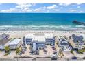 Aerial view of a condo building with a beach, ocean, and pier in the background at 200 N Waccamaw Dr. # 3F, Murrells Inlet, SC 29576