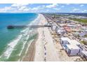 Scenic aerial view of the beach and condo building with a fishing pier nearby at 200 N Waccamaw Dr. # 3F, Murrells Inlet, SC 29576