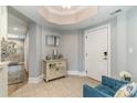 Hallway view with tiled floors, a decorative cabinet, mirror, and a glimpse into the home's elegant interior at 2180 Waterview Dr. # 727, North Myrtle Beach, SC 29582